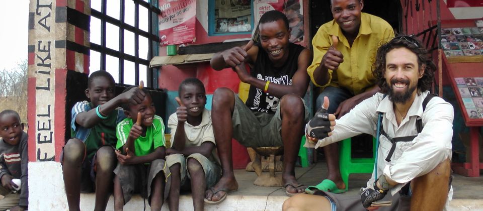 Taking a break from cycling with friendly locals, Zambia, 29 yrs old